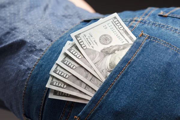 Pack of dollar banknotes in woman jeans pocket — Stock Photo, Image