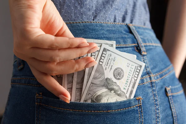 Woman hand pick pack of 100 dollar banknotes from pocket — Stock Photo, Image