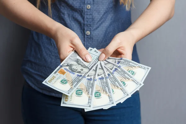 Fan of 100 dollar banknotes in woman hands — Stock Photo, Image