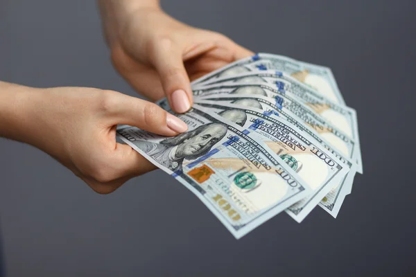 Fan of 100 dollar banknotes in woman hands — Stock Photo, Image