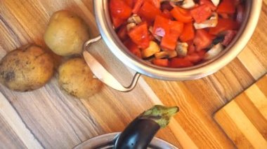 Sağlıklı gıda yaşam tarzı: güzel kadın rahat yemek, mutfakta tavada sebze kadar karıştırma. Yukarıdan aşağıya çekim, el, yavaş çekim 60 fps.