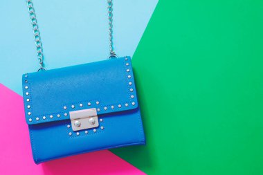 Yeşil arka planda el çantası olan deri çanta.