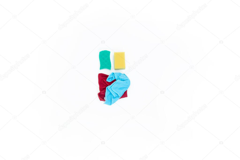 bright modern flat lay top view close up minimal photo of Cleaning Equipment , sponges and colorful rags on white background whith copy space