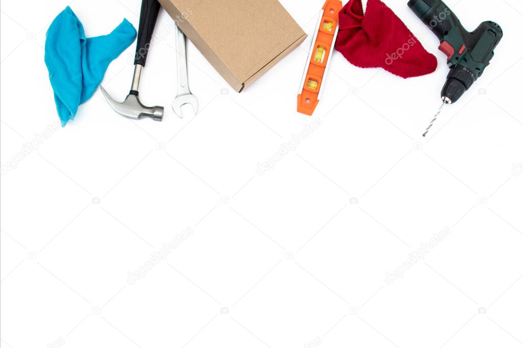 bright modern flat lay top view close up photo of random colorful tools for handyman,hammer,screwdriver,screws,patch,box on white clean background