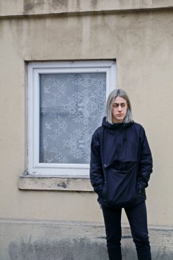 Pencereli, eski evin yakınında mavi elbiseli bir kız.