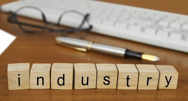 The word industry on wood stamp — Stock Photo, Image