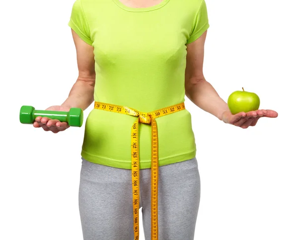 Woman with dumbbells and apple — Stock Photo, Image