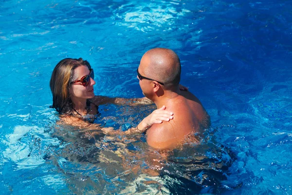 Pareja feliz en la piscina — Foto de Stock