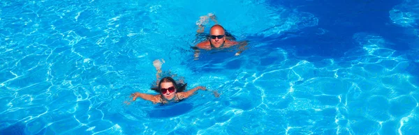 Paar schwimmt im Pool — Stockfoto