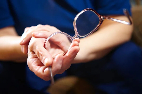 Öregasszony kezét a szemüvegem — Stock Fotó