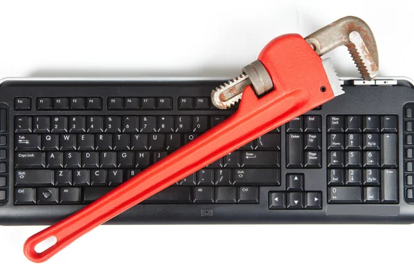 Adjustable wrench and keyboard — Stock Photo, Image