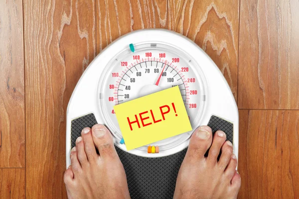 A pair of man's feet standing on a scale — Stock Photo, Image