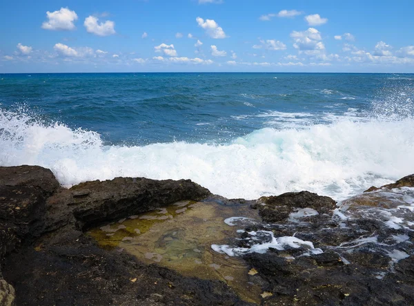 Rock kıyısında büyük dalgalar deniz ve Girit gökyüzü mavi