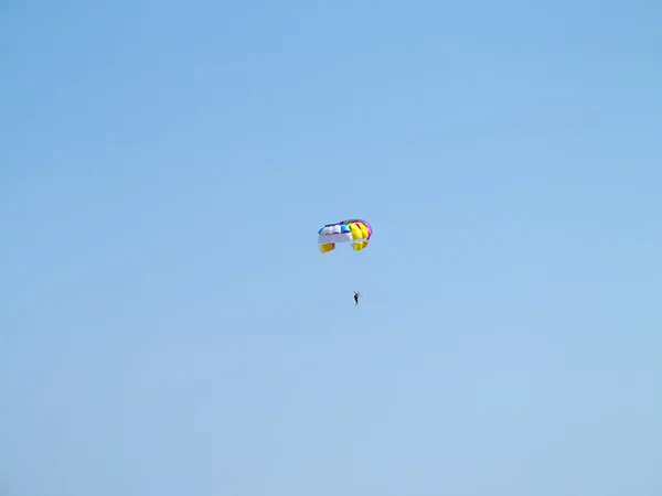 Colorful parachute over blue sky background — Stock Photo, Image