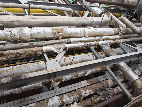 Old rusty industrial steel pipelines, valves and equipment at po — Stock Photo, Image