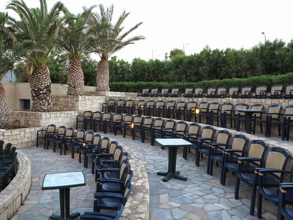 Modern amphitheater plastic chairs and palm trees in Greece — Stock Photo, Image