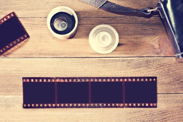 Photographic film on wooden background.