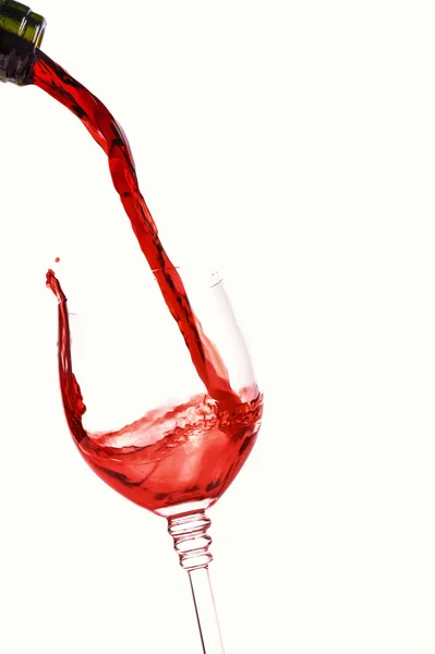 Red wine splashing in glass — Stock Photo, Image