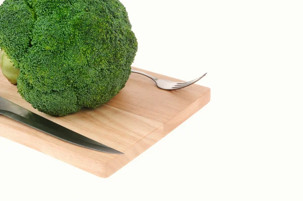 Broccoli on cutting board with knife and fork  isolated on white — Stock Photo, Image