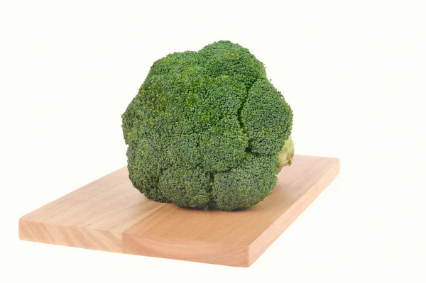 Broccoli on cutting board isolated on white — Stock Photo, Image