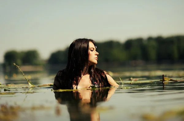 Sexy brunette woman in water. summer season — Stock Photo, Image