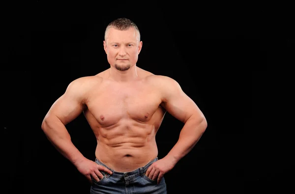 Muscular male posing on black background — Stock Photo, Image