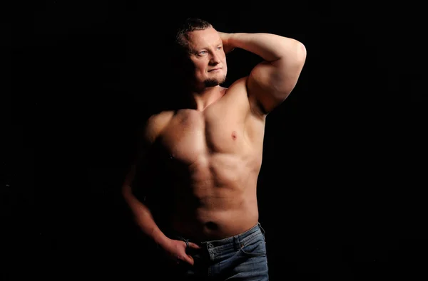 Mięśni mężczyzna pozowanie na czarnym tle — Zdjęcie stockowe
