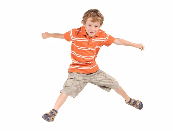 Springender Junge vor weißem Hintergrund — Stockfoto