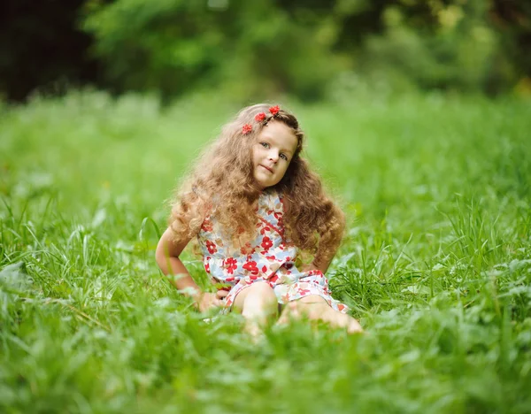 Kleines hübsches Mädchen im grünen Garten — Stockfoto