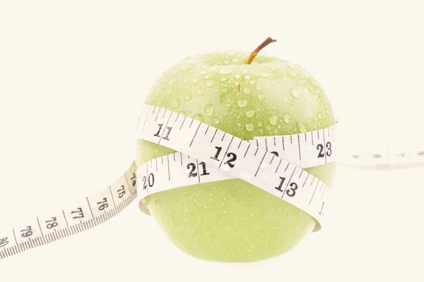 Green apple measured the meter — Stock Photo, Image