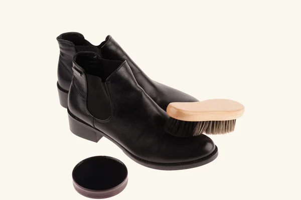 Black boots with shoe brush — Stock Photo, Image