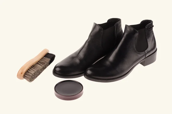 Black boots with shoe brush — Stock Photo, Image