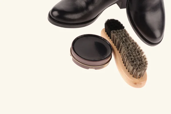 Black boots with shoe brush — Stock Photo, Image