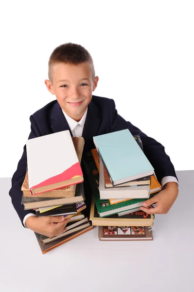 Skolpojke med enorma högen med böcker — Stockfoto