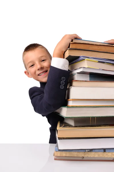 Schoolboy with huge stack of books — Stock Photo, Image