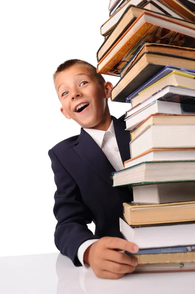 Surprised schoolboy with huge stack of books — Stock Photo, Image