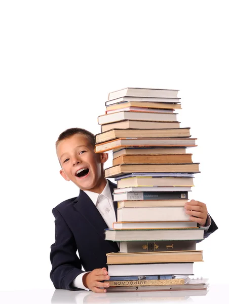 Surprised schoolboy with huge stack of books — Stock Photo, Image