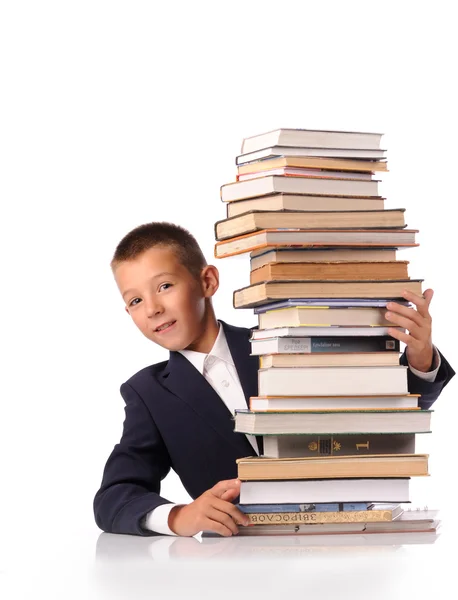 Schüler mit riesigem Bücherstapel — Stockfoto