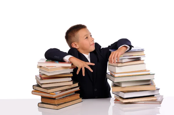 Schoolboy with huge stack of books — Stock Photo, Image