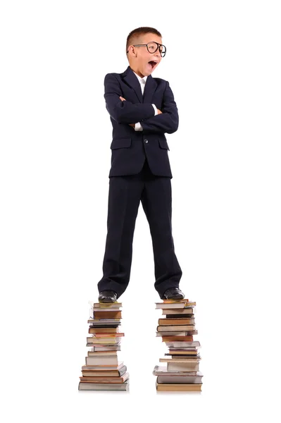 Schoolboy gritando na pilha enorme de livros — Fotografia de Stock