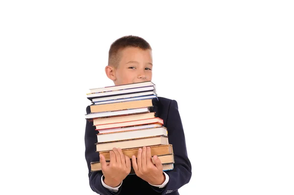 Colegial sosteniendo enorme pila de libros — Foto de Stock