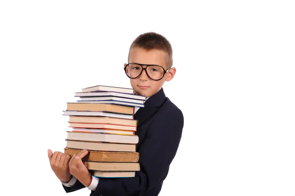 Schoolboy segurando enorme pilha de livros — Fotografia de Stock