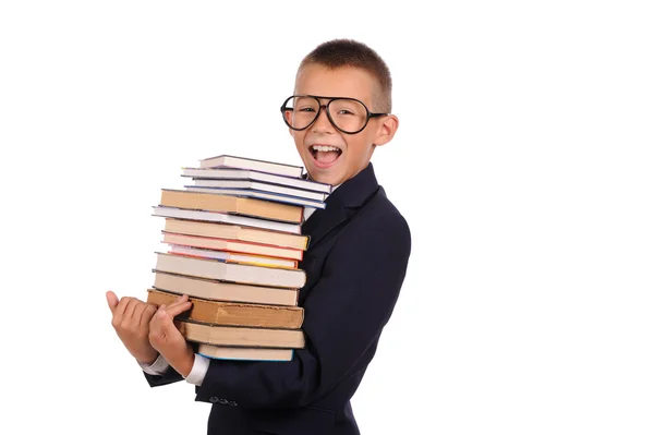 Schoolboy segurando enorme pilha de livros — Fotografia de Stock