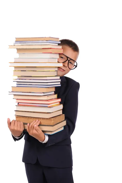 Schoolboy segurando enorme pilha de livros — Fotografia de Stock