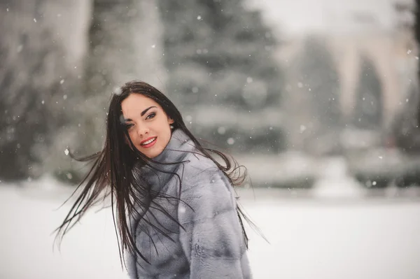 winter portrait of Beauty girl with snow