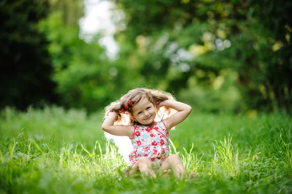 Pequena menina bonita no jardim verde — Fotografia de Stock