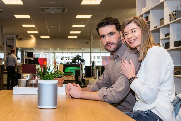 Pareja con altavoz en contador en la tienda de electrónica —  Fotos de Stock