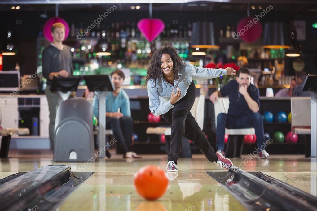 Young black woman plays bowling Stock Photo by ©Corepics 103536070