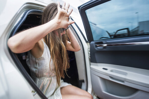 Celebrity exiting a stretch limousine