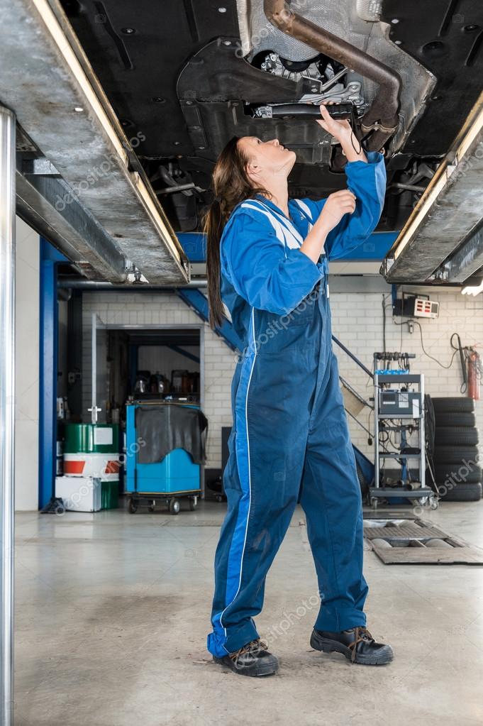 Female mechanic repairing car — Stock Photo © Corepics 125218892